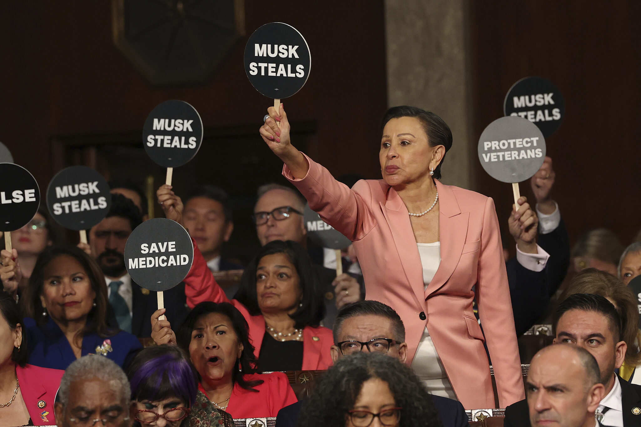 Losers democrats hold pathetic signs during trump speech to joint