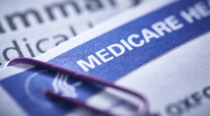 closeup of a Medicare health insurance card with a paperclip