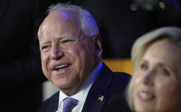 Democratic vice presidential nominee Minnesota Gov. Tim Walz and his wife Gwen Walz watch during the Democratic National Convention Monday, Aug. 19, 2024, in Chicago. (AP Photo/Erin Hooley)