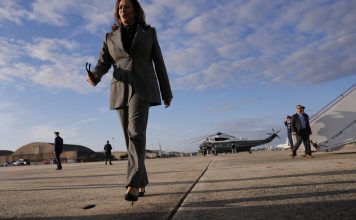 Democratic presidential nominee Vice President Kamala Harris walks over to speak to members of the media upon her arrival at Andrews Air Force Base, Md., Sunday, Sept. 22, 2024. (AP Photo/Matt Rourke/Pool)