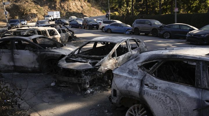 Abandoned cars, some burned by Palisades Fire, sit on the side of a road Monday, Jan. 13, 2025, in the Pacific Palisades neighborhood of Los Angeles. (AP Photo/John Locher)