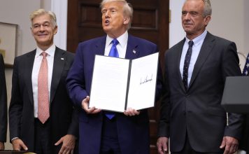 President Donald Trump, with Dr. Mehmet Oz, Administrator of the Centers for Medicare & Medicaid Services, left, and Health and Human Services Secretary Robert F. Kennedy Jr., right, holds an executive order related to drug prices, in the Roosevelt Room of the White House in Washington, Monday, May 12, 2025, in Washington. (AP Photo/Mark Schiefelbein)