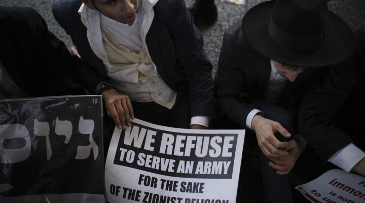 Ultra-Orthodox Jewish men block a highway during a protest against army recruitment in Bnei Brak, Israel, Thursday, June 5, 2025. (AP Photo/Leo Correa)