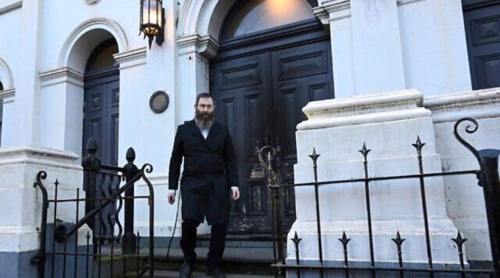 Rabbi Dovid Gutnick walks past damage to the exterior of the East Melbourne Hebrew Congregation in Melbourne, July 5, 2025, after an arsonist set fire to the door. (James Ross/AAP Image via AP)