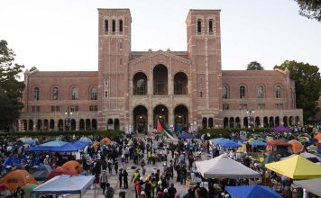 FILE - Demonstrators walk in an encampment on the UCLA campus after clashes between pro-Israel and pro-Palestinian groups, May 1, 2024, in Los Angeles. (AP Photo/Jae C. Hong, File)