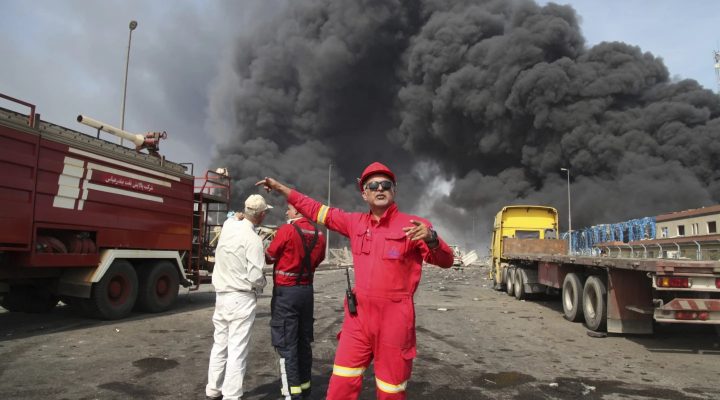 In this photo provided by Islamic Republic News Agency (IRNA) firefighters work as black smoke rises in the sky after a massive explosion rocked a port near the southern city of Bandar Abbas, Iran, Saturday, April 26, 2025. (Mohammad Rasoul Moradi/IRNA via AP)