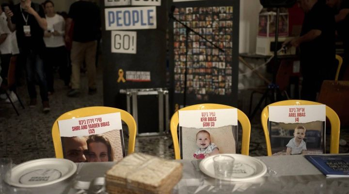 Chairs for the Bibas family, hostages held in Gaza at a Pesach seder table set on Thursday, April 11, 2024 at the communal dining hall at Kibbutz Nir Oz in southern Israel, where a quarter of all residents were killed or abducted by Hamas on Oct. 7, 2023. (AP/Maya Alleruzzo)
